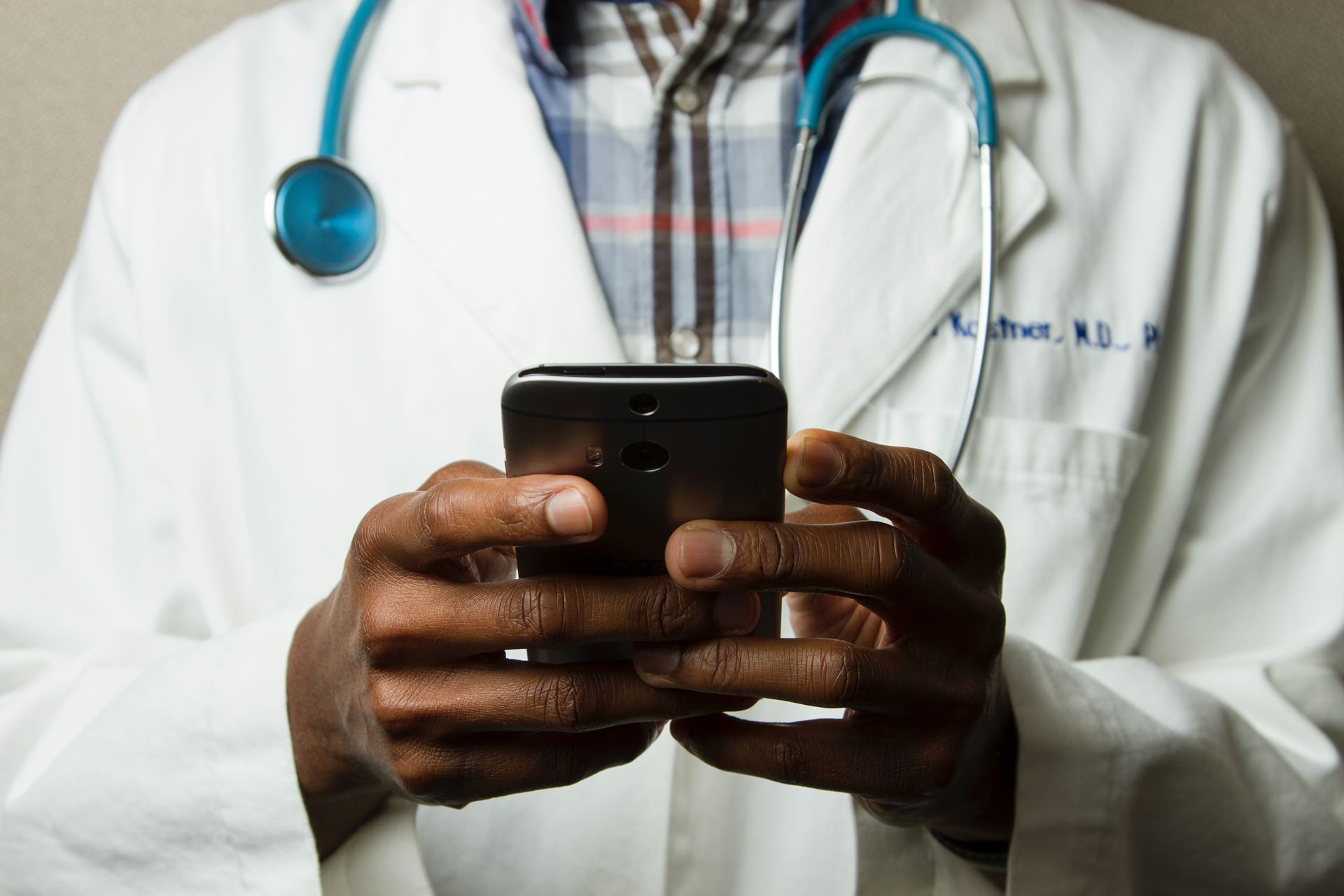 a doctor holding a mobile phone