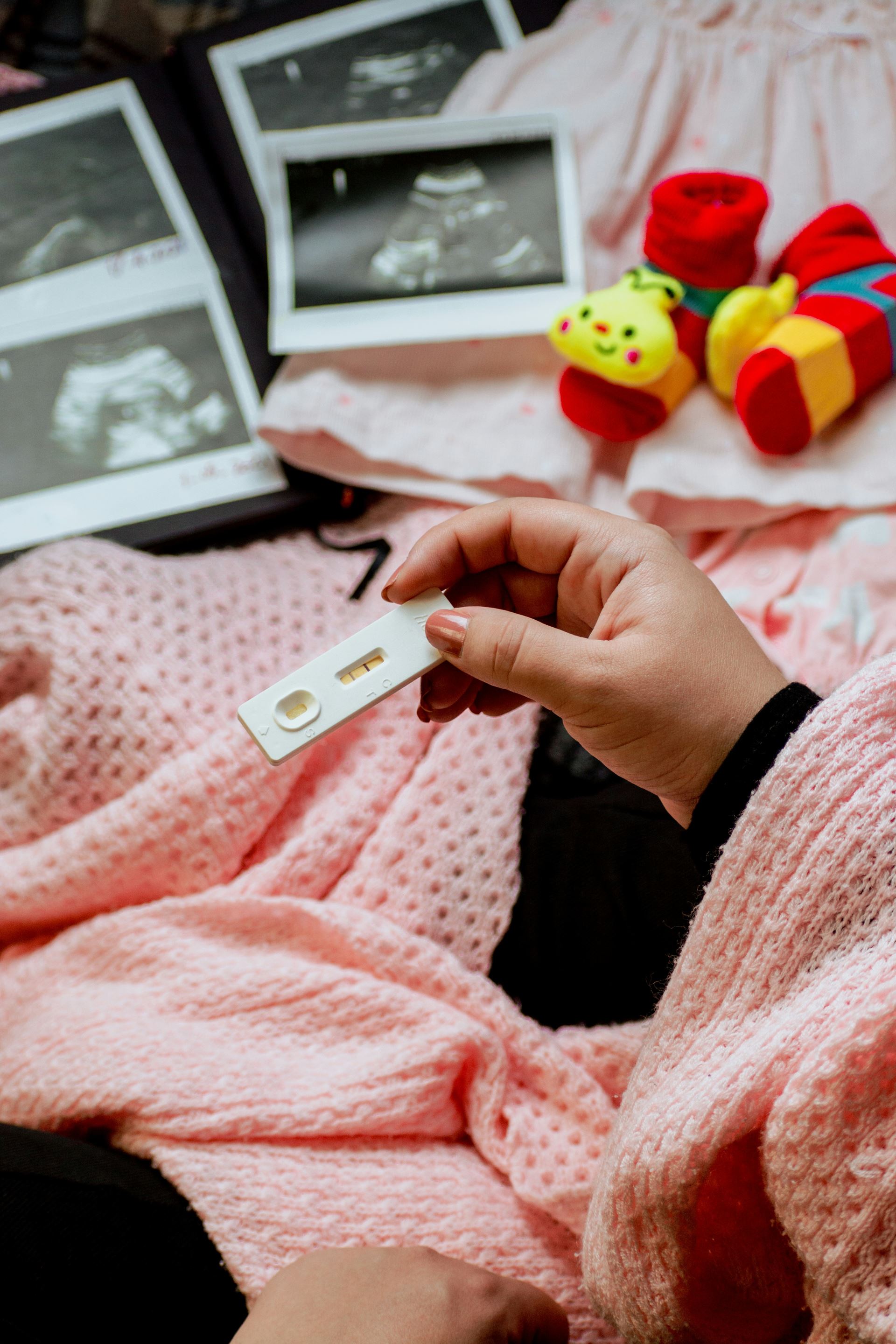 womens hand holding pregnancy test